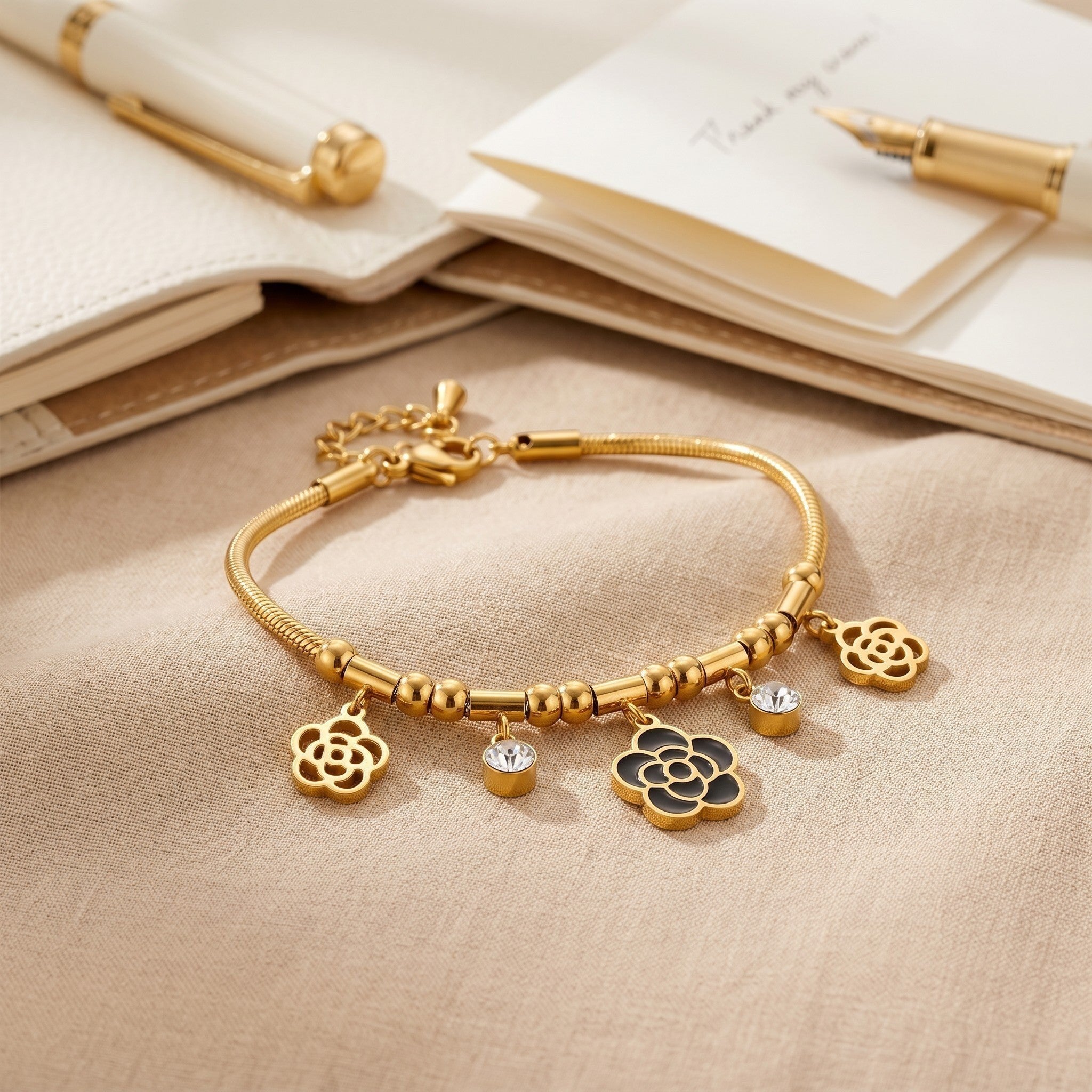Złota Kraków gold-plated surgical steel bracelet with black rose charms and clear crystals. 17cm + 3cm adjustable.