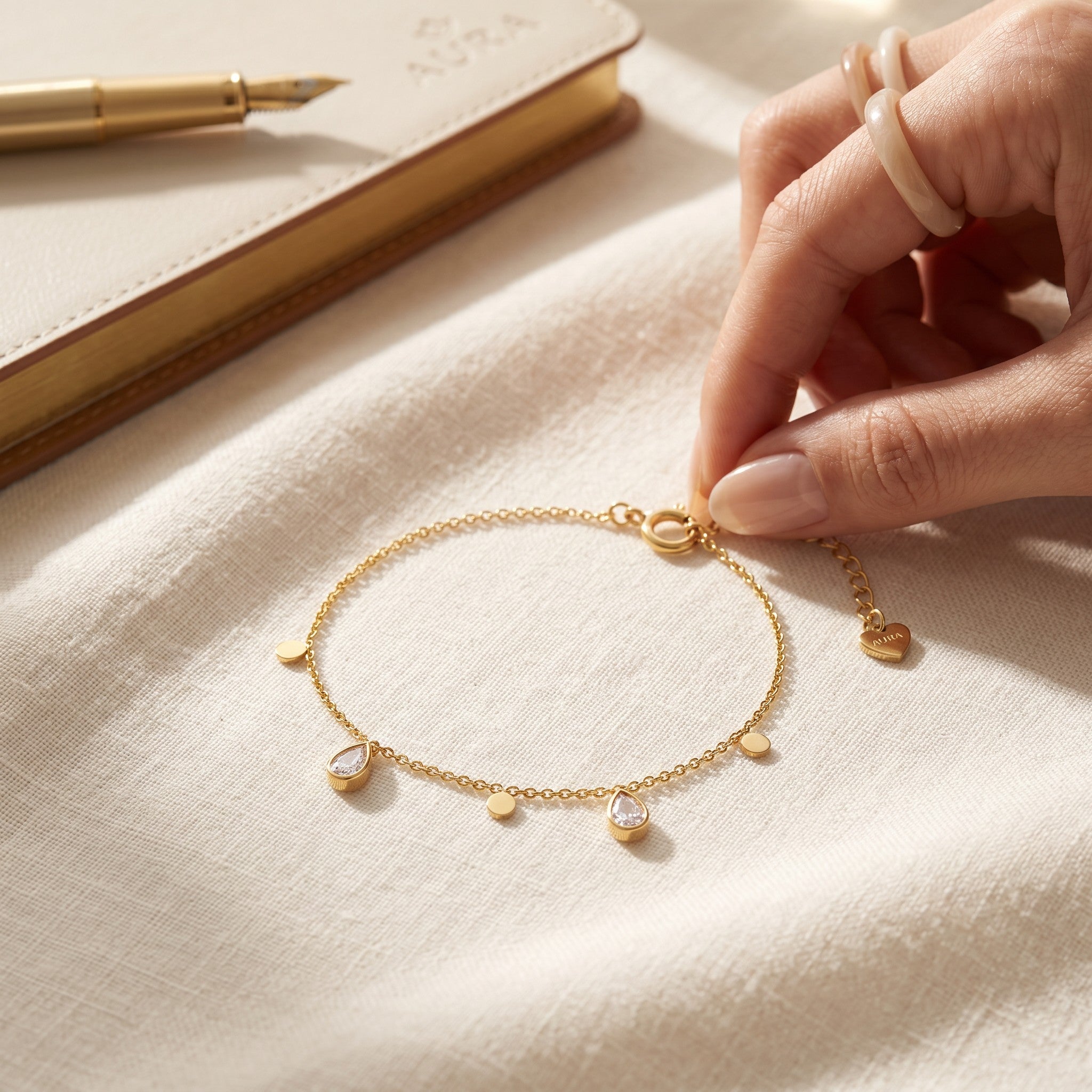 Złota Kraków delicate gold-plated surgical steel bracelet with teardrop crystals and small discs. Adjustable length.