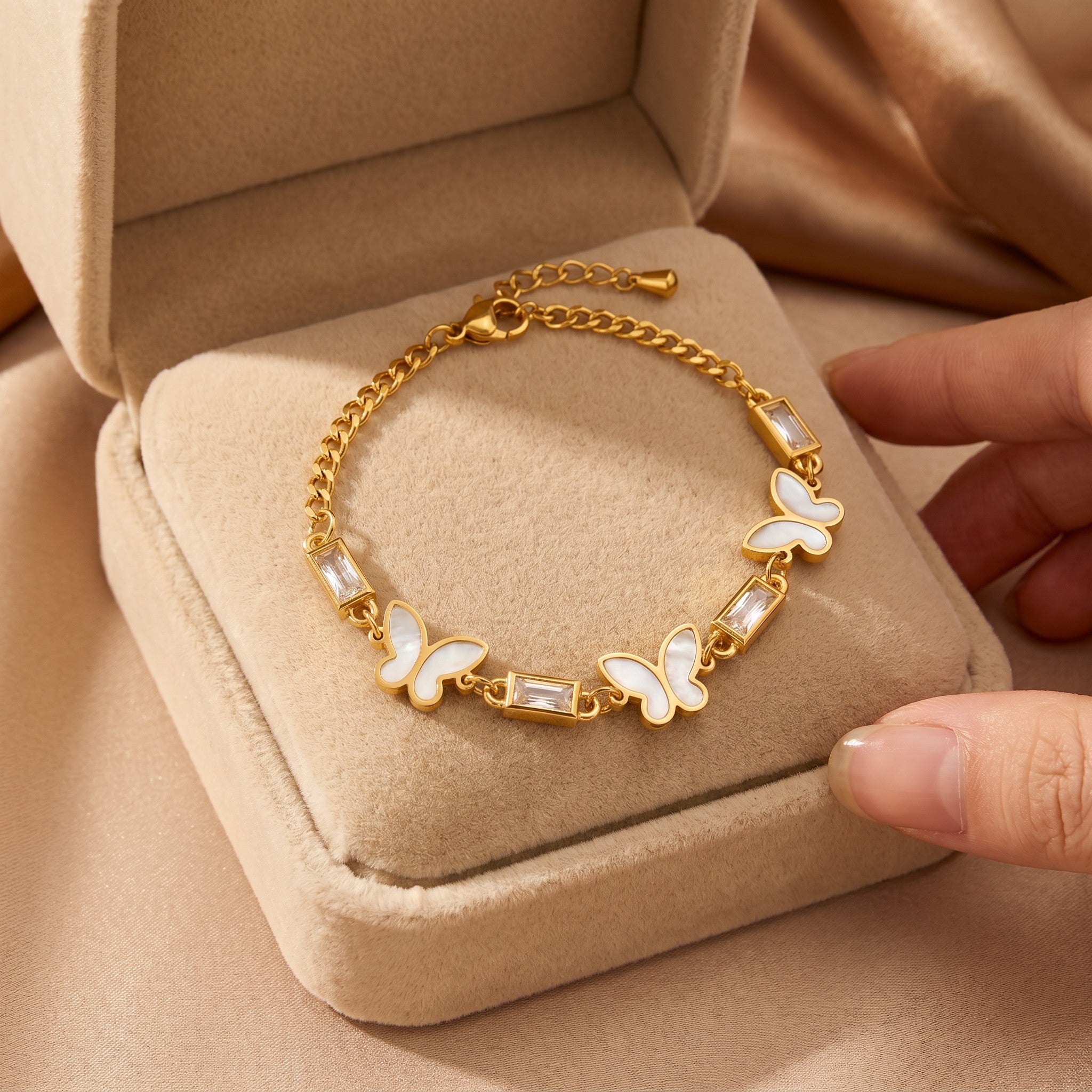 Złota Kraków gold-plated stainless steel bracelet with white butterfly charms and baguette crystals. 17cm + 3cm adjustable.