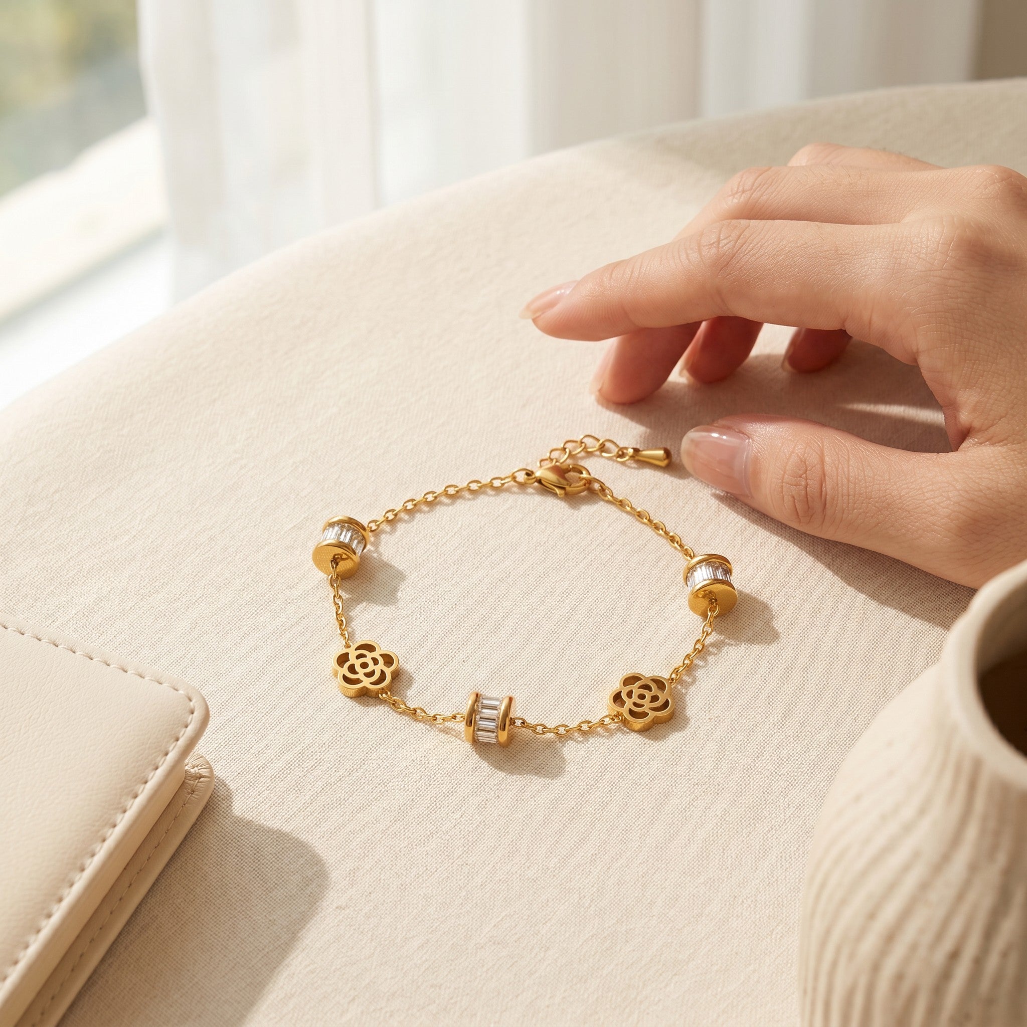 Złota Kraków gold-plated surgical steel bracelet with flower charms and baguette crystal accents. Adjustable 17cm length.