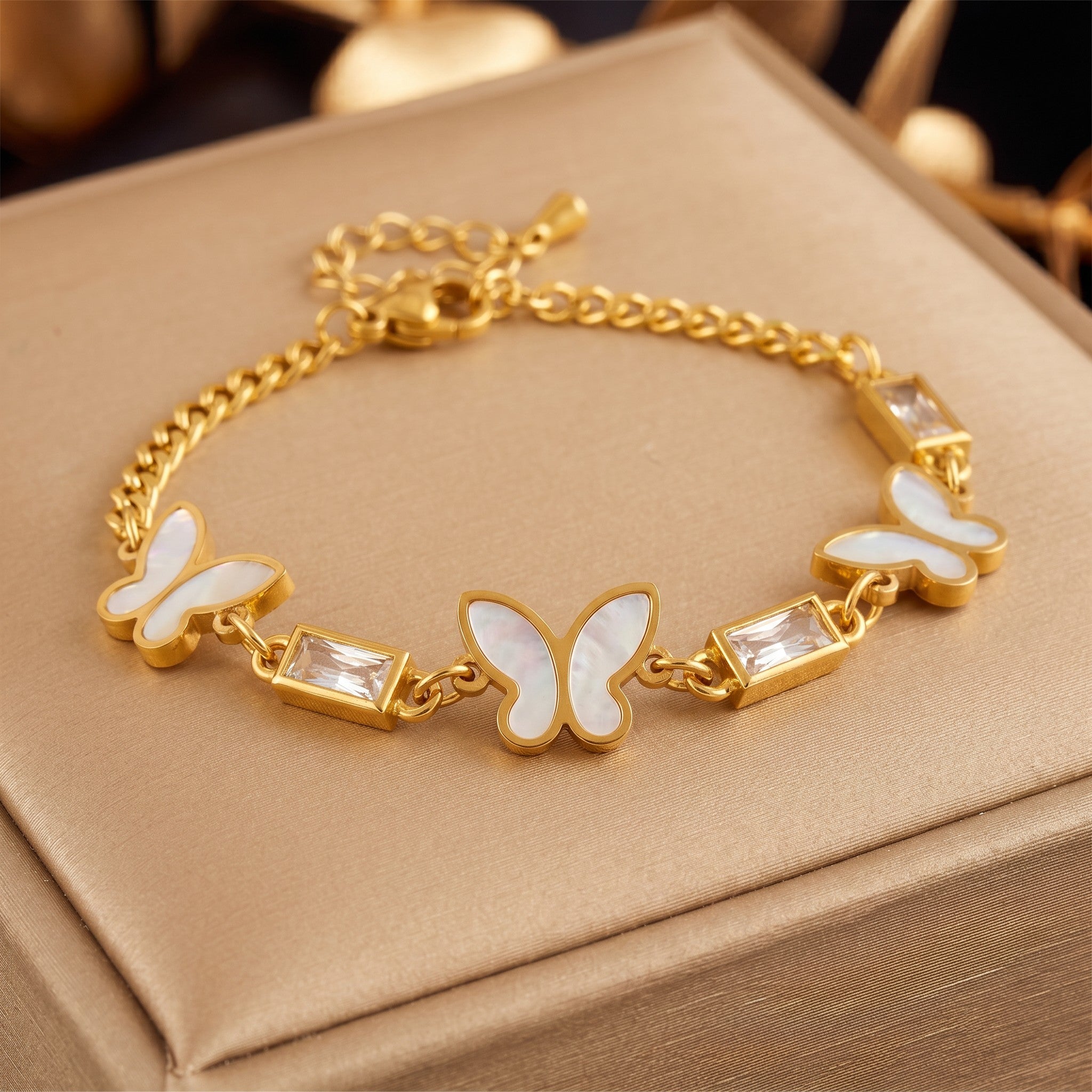 Złota Kraków gold-plated 18K surgical steel bracelet with white mother-of-pearl butterfly charms and baguette crystals.