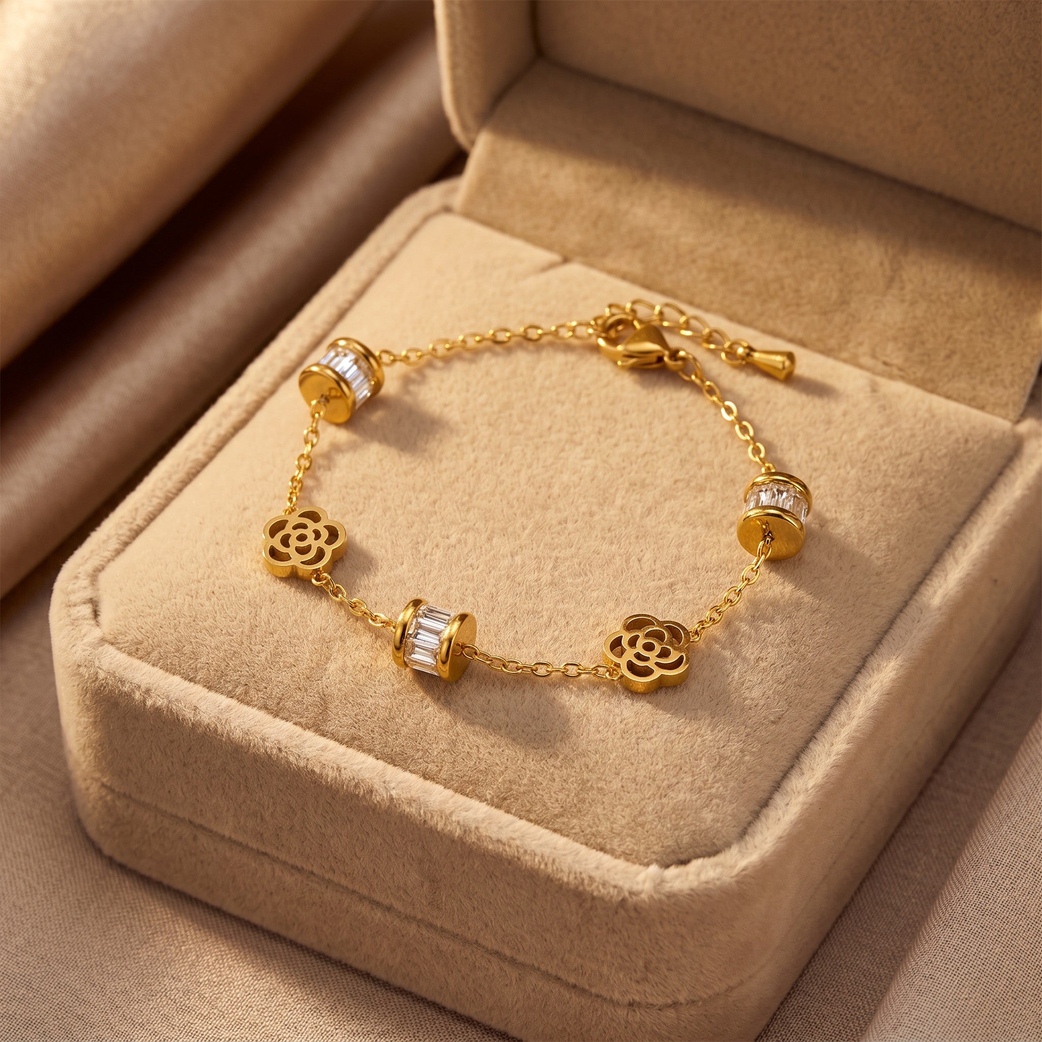 Złota Kraków gold-plated surgical steel bracelet with flower charms and baguette crystal accents. Adjustable length.