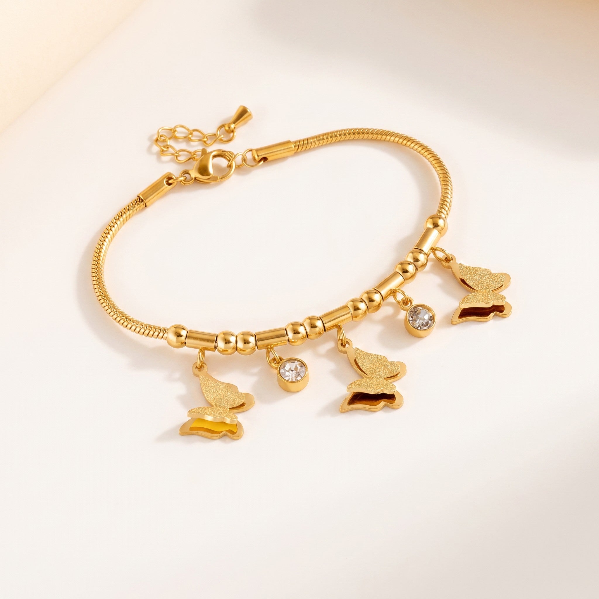 Złota Kraków gold-plated surgical steel bracelet with butterfly charms and clear crystals. 17cm + 3cm adjustable.