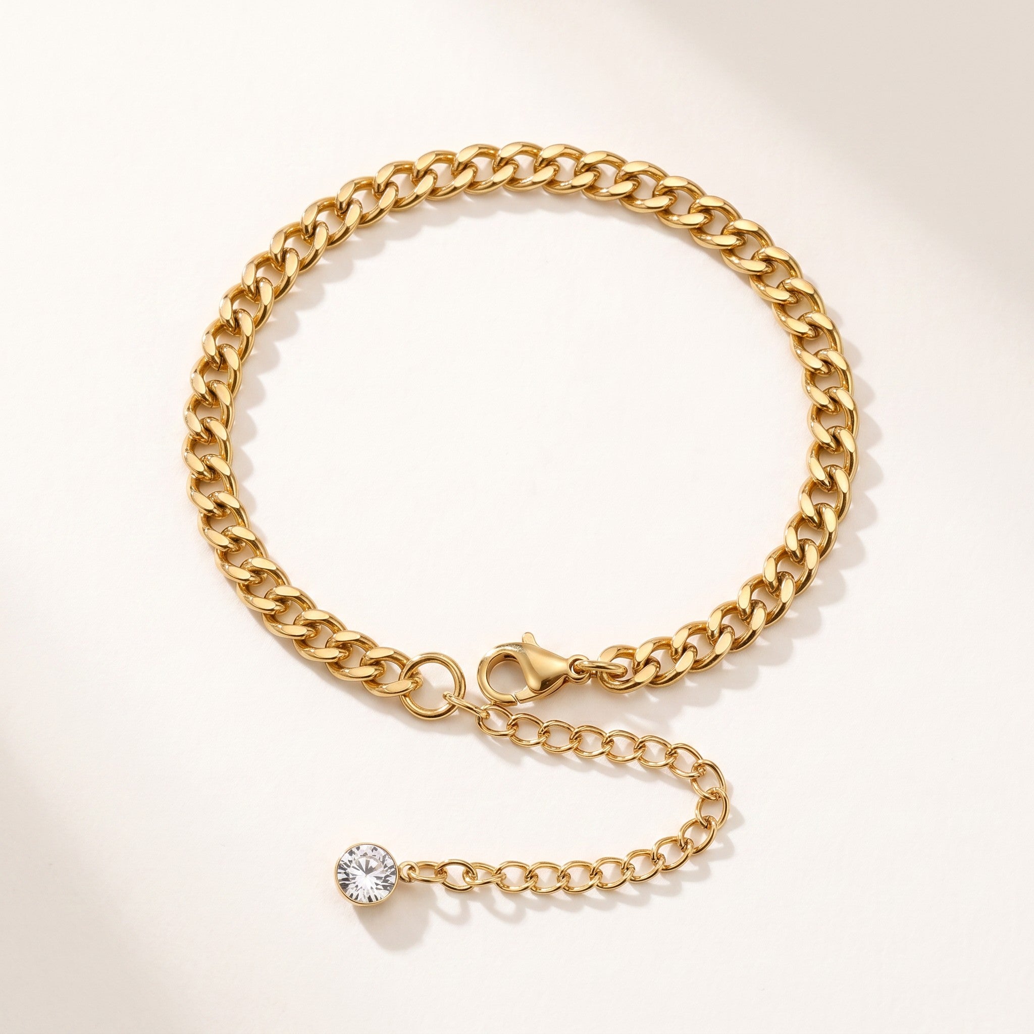 Złota Kraków gold-plated surgical steel curb chain bracelet with adjustable length and a single clear crystal accent.