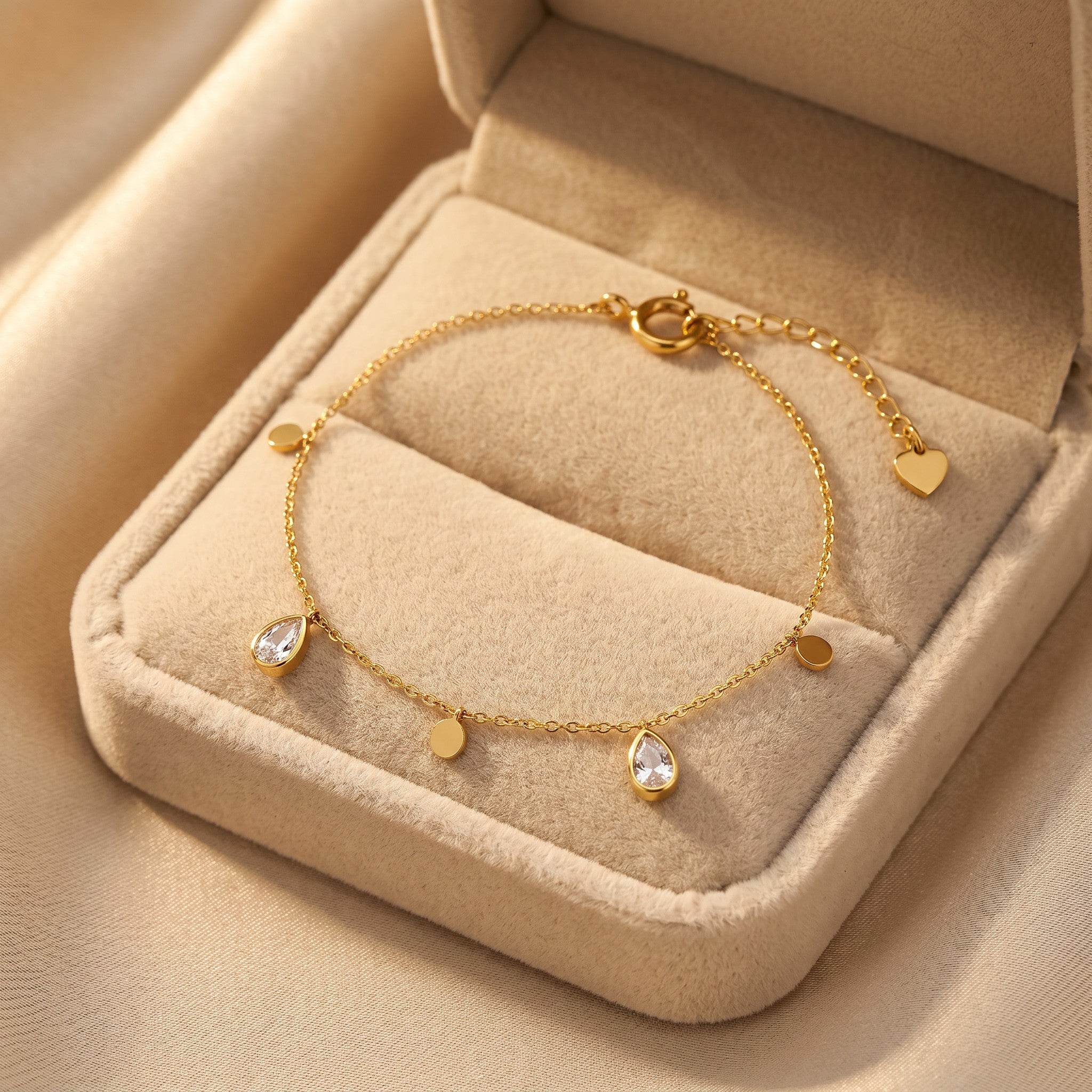 Złota Kraków delicate gold-plated surgical steel bracelet with teardrop charms and small discs, adjustable length.