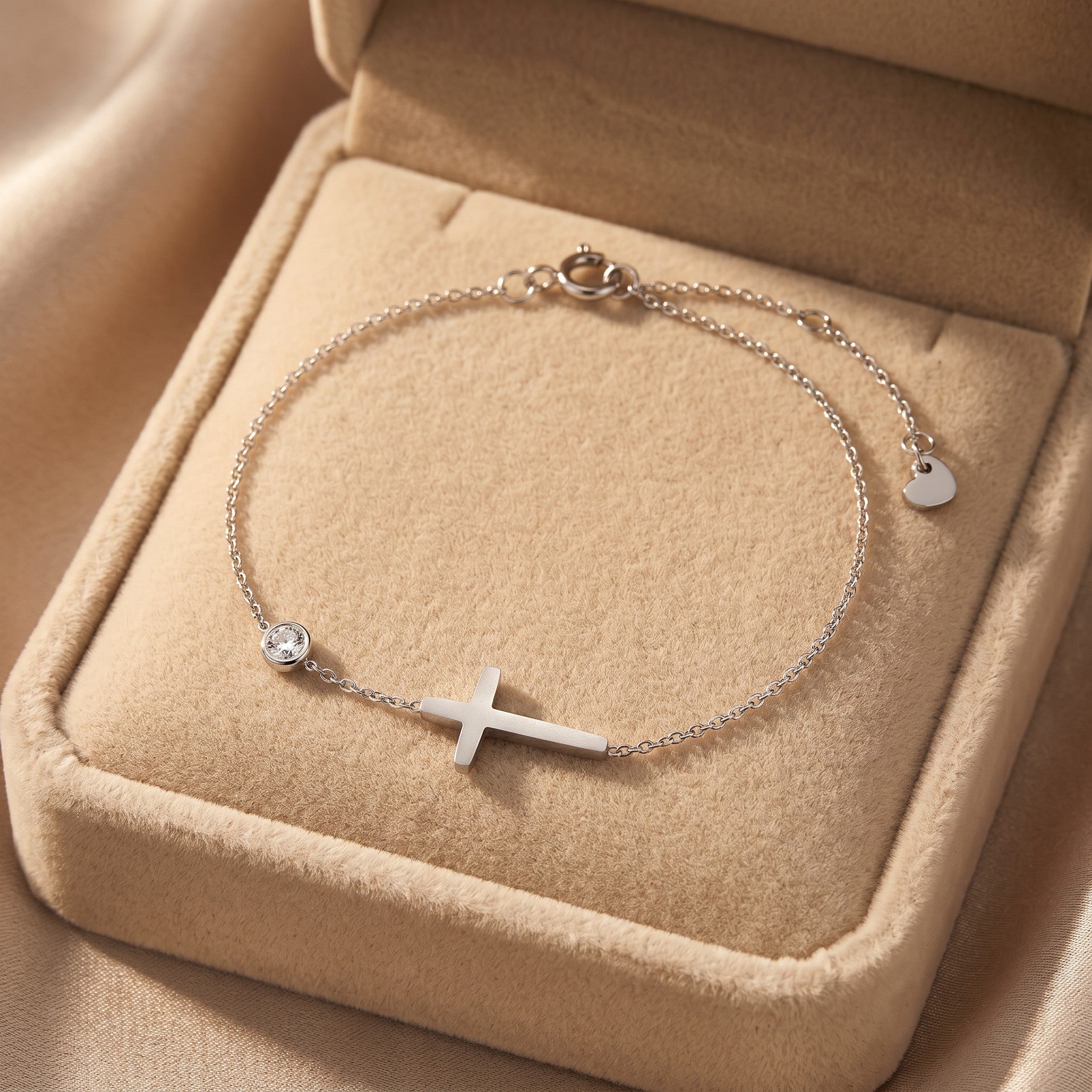 Złota Kraków silver-tone surgical steel bracelet with a sideways cross charm and a clear crystal accent.