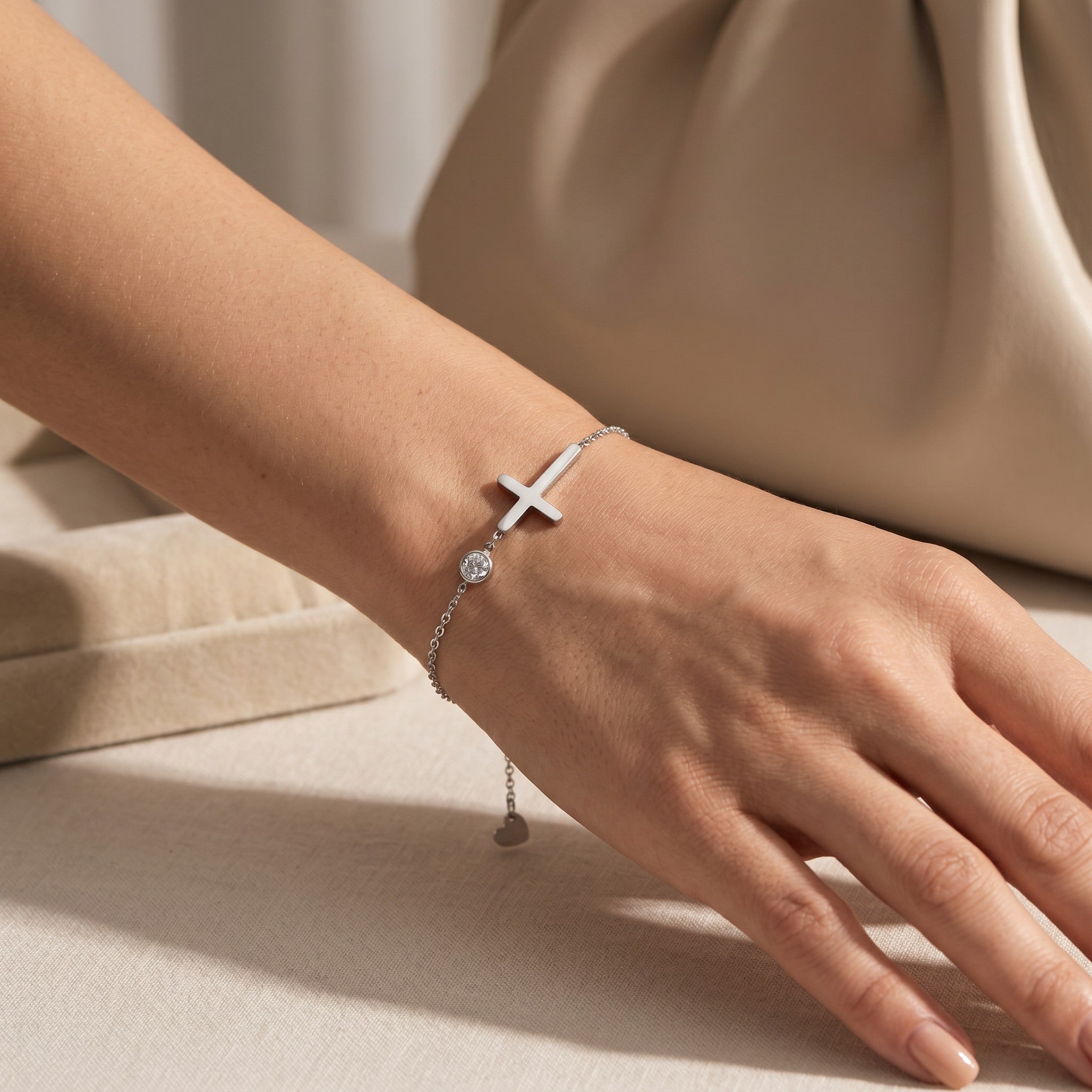 Złota Kraków silver-tone surgical steel bracelet with cross charm and clear crystal accent, adjustable length.