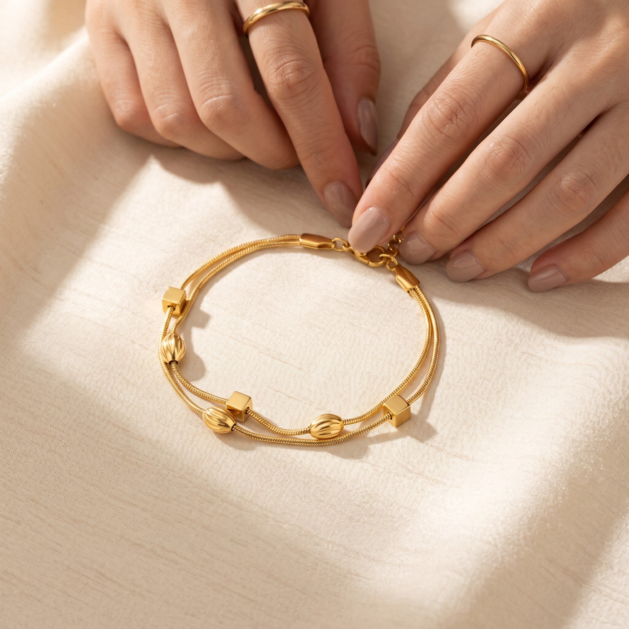 Złota Kraków double chain bracelet with gold-plated surgical steel, featuring cube and oval beads. 17cm + 3cm adjustable.