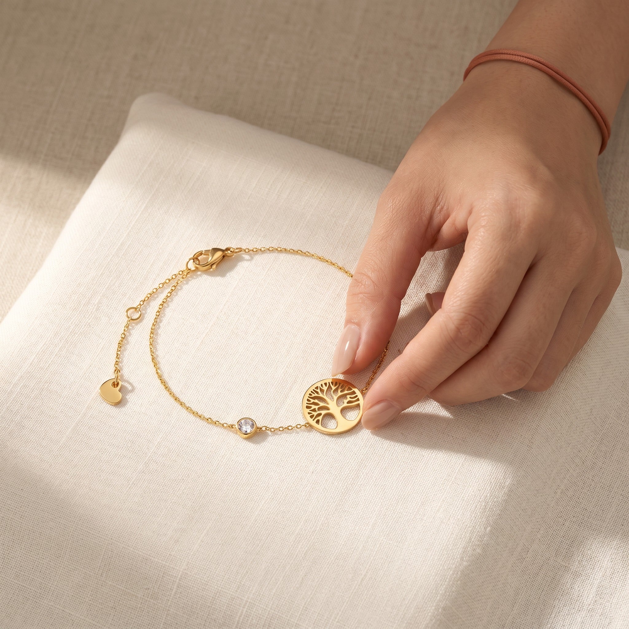 Złota Kraków gold-plated surgical steel bracelet with a tree of life charm and a clear stone.