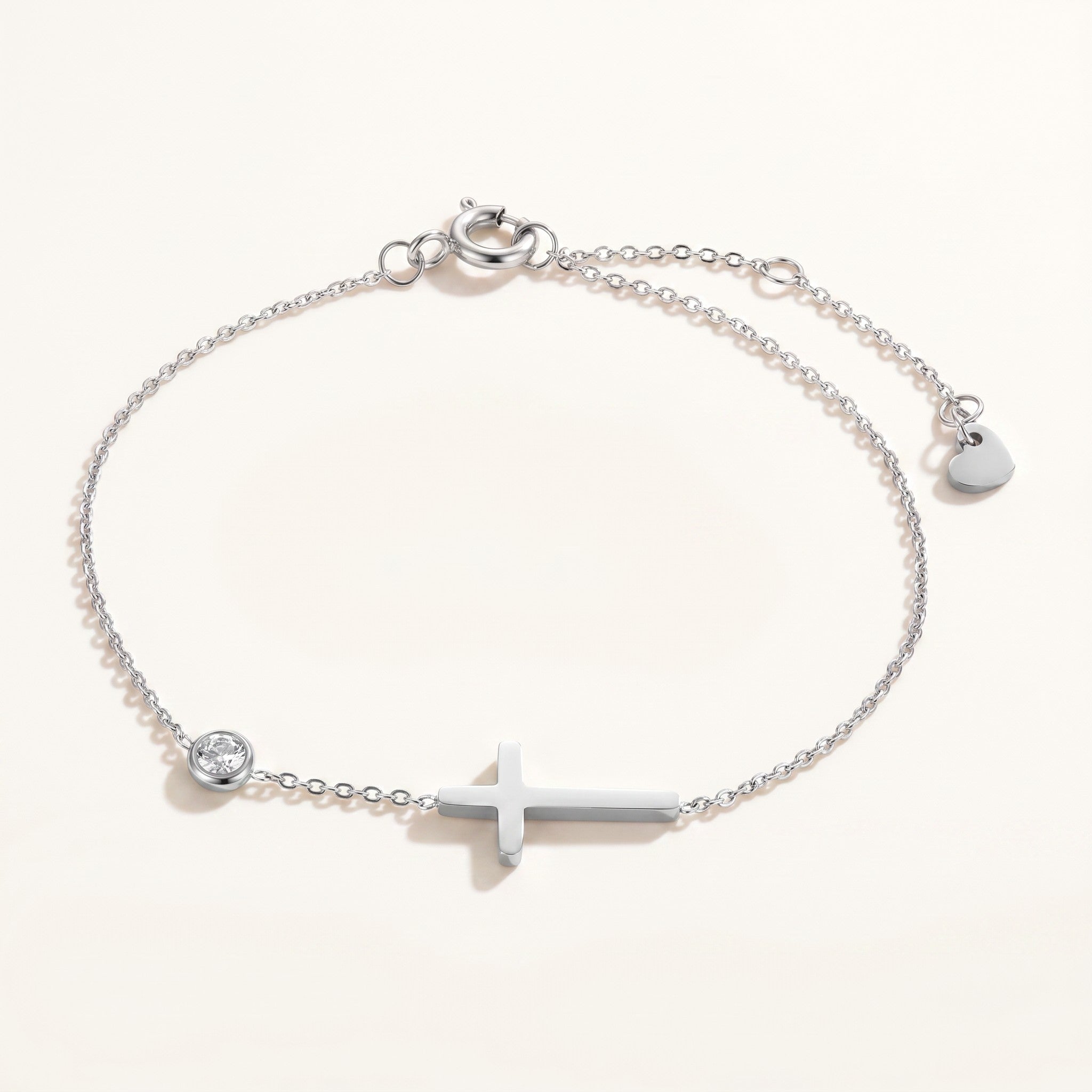 Złota Kraków silver-tone surgical steel bracelet with a cross charm and a clear crystal accent. Adjustable length.