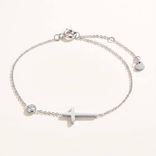 Złota Kraków silver-tone surgical steel bracelet with a cross charm and a clear crystal accent. Adjustable length.